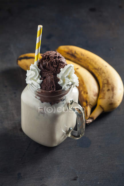Smoothie in glass with bananas — Stock Photo