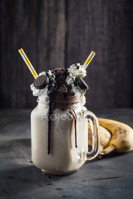 Smoothie in glass with bananas — Stock Photo