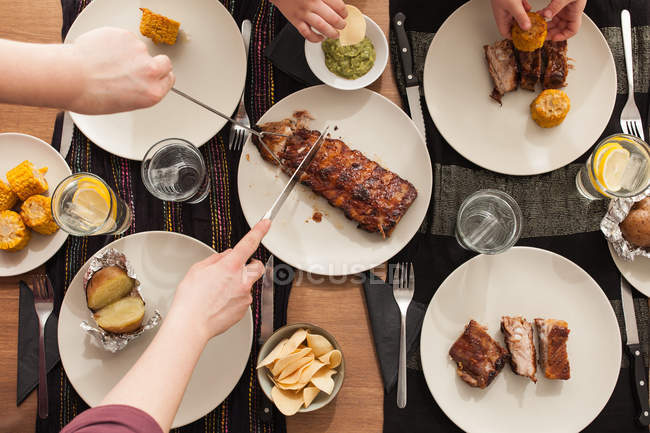 Table with grilled ribs, potatoes and corn — Stock Photo