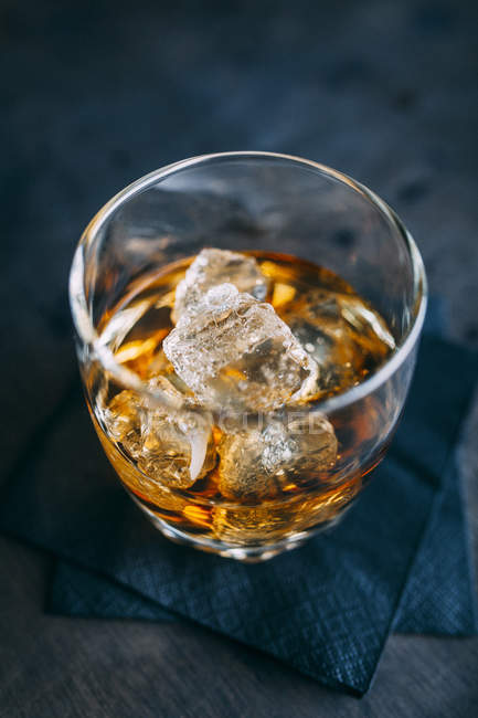 Glass of cognac with ice — Stock Photo