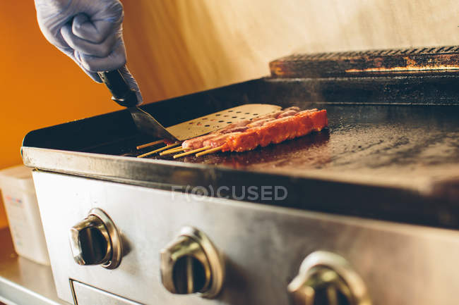 Cook preparing food in food truck — Stock Photo