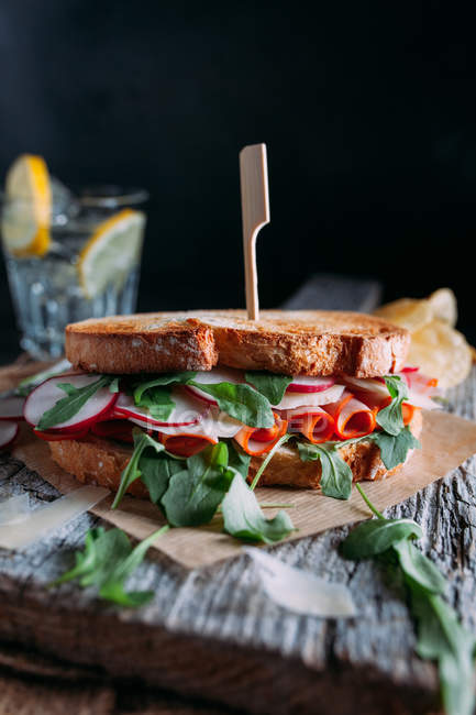 Sandwich with ham, radish and arugula — Stock Photo