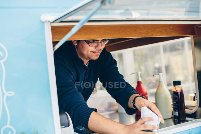 Young man in food truck — Stock Photo