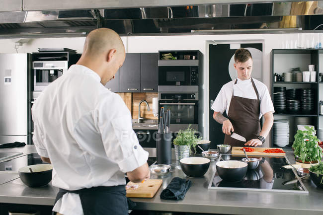 Chef and student cooking in kitchen — Stock Photo