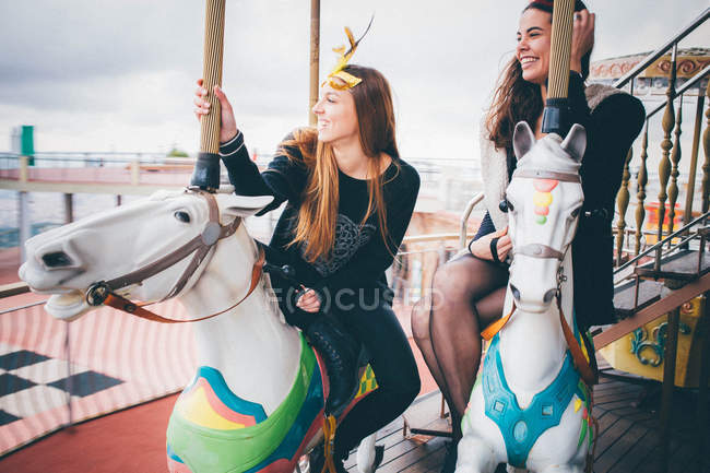 Красивые женщины веселятся на карусели — стоковое фото
