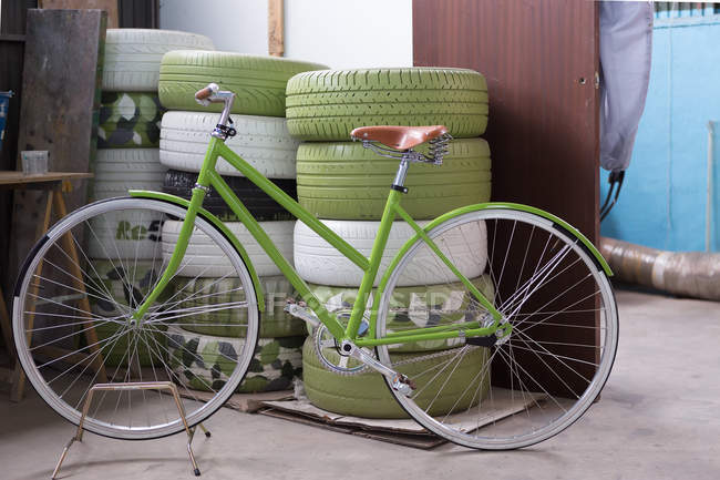 Green bicycle in garage — Stock Photo