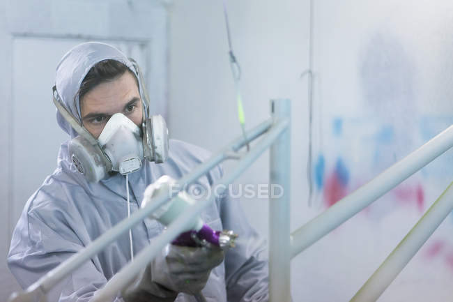 Painter in process of painting frame — Stock Photo