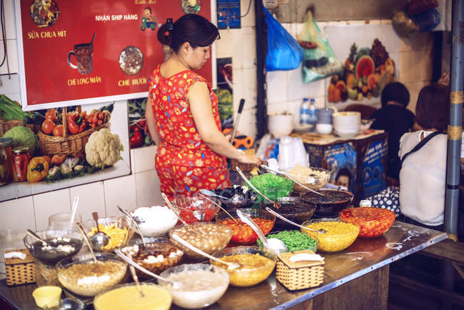 Clientes en puestos callejeros en Hanoi - foto de stock