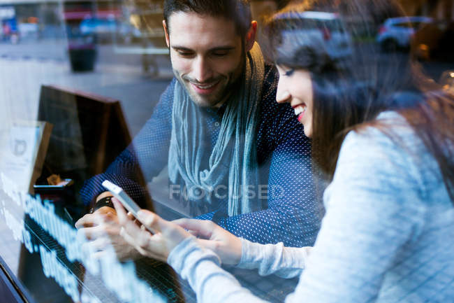 Giovane coppia utilizzando il telefono cellulare — Foto stock