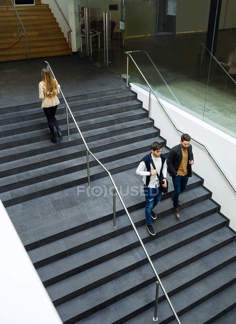Uomini d'affari che camminano nelle scale . — Foto stock