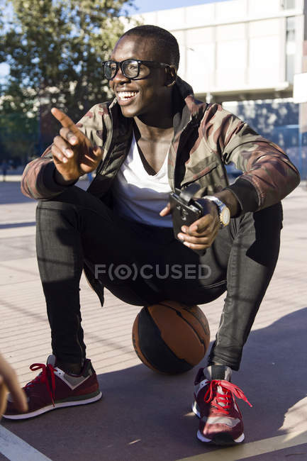 Young man sitting on ball — Stock Photo