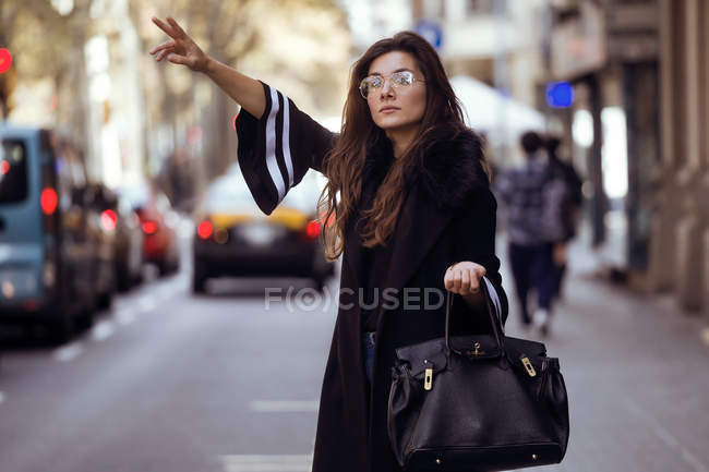 Woman calling taxi — Stock Photo