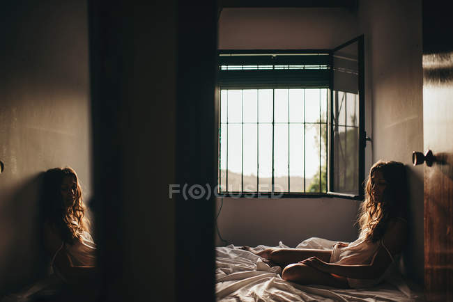 Solitario bruna ragazza su letto — Foto stock