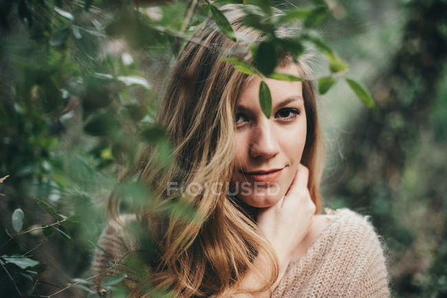 Beautiful young blonde girl with hand on neck — Stock Photo