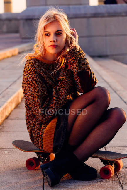 Girl sitting on skate — Stock Photo