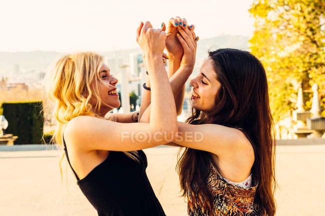 Girls holding bended hands up — Stock Photo
