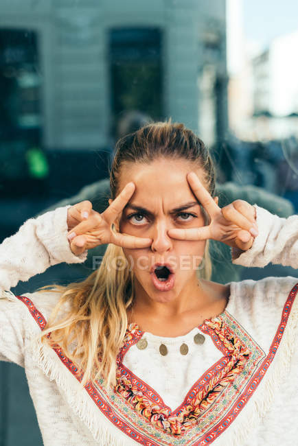 Young blonde girl grimaces — Stock Photo