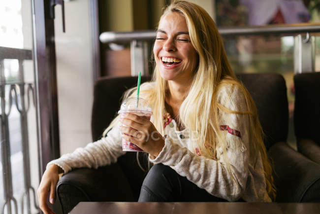 Young blonde woman with cocktail — Stock Photo