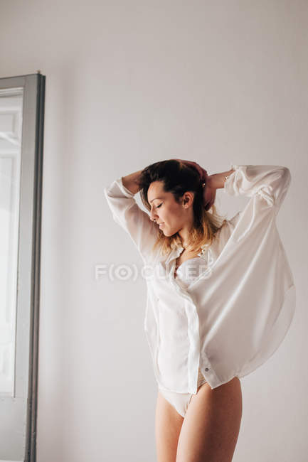 Young woman stretching at home — Stock Photo