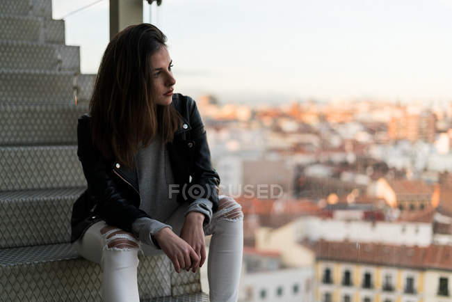 Woman sitting on stairs at city — Stock Photo
