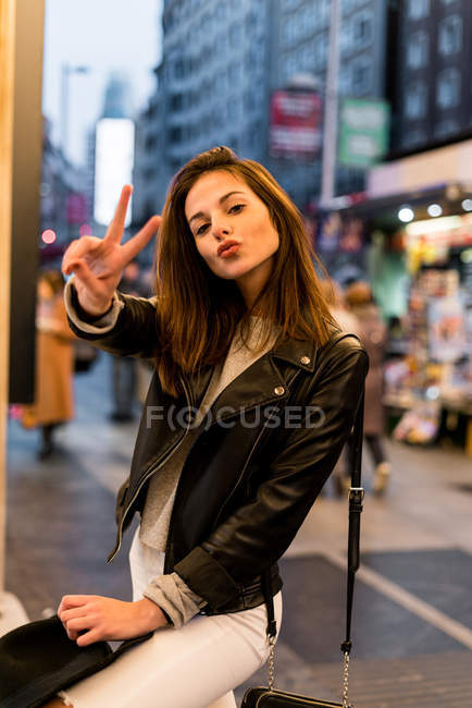Woman gesturing with two fingers — Stock Photo