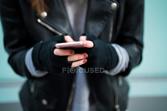 Casual dressed woman browsing phone — Stock Photo