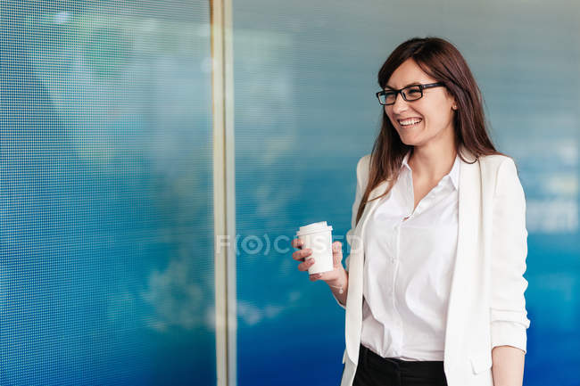 Elegant laughing woman with coffee to go — Stock Photo