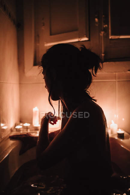 Dark silhouette of woman in bath — Stock Photo