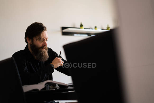 Pensive man working at home — Stock Photo