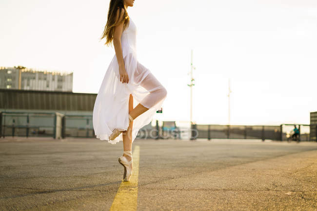 Low section of ballet dancer at city square — Stock Photo