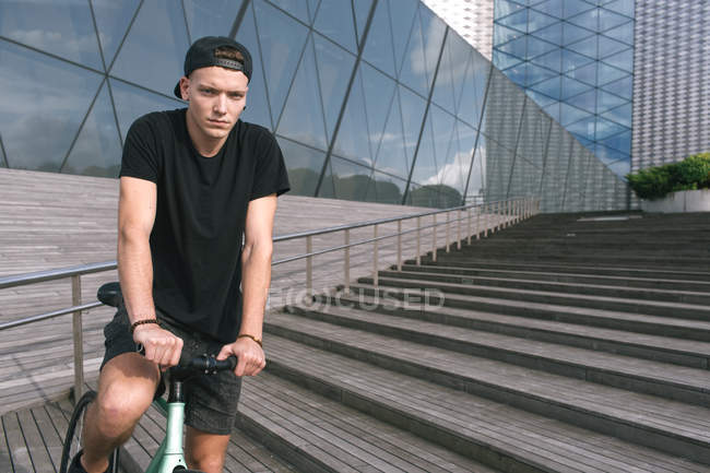 Boy in black on bike — Stock Photo