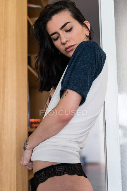 Woman in tshirt and black lace pants — Stock Photo