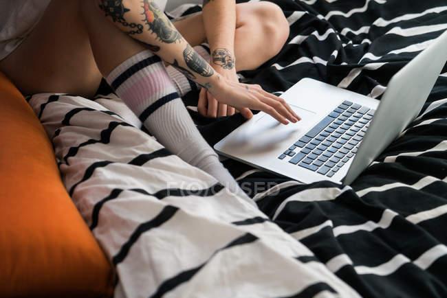 Crop shot of woman using laptop — Stock Photo