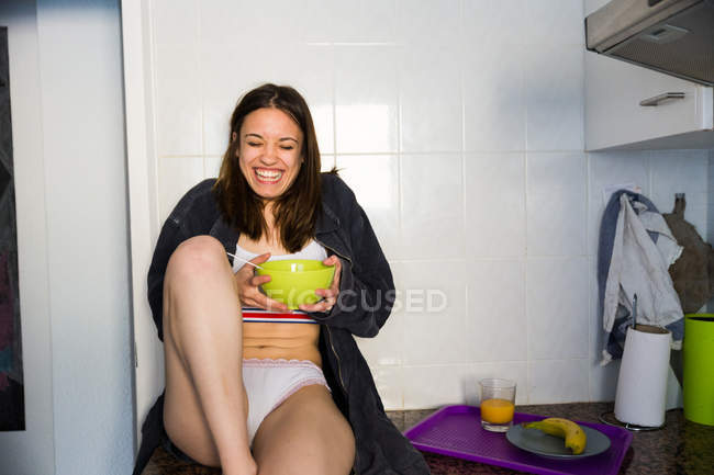 Cheerful brunette having breakfast — Stock Photo