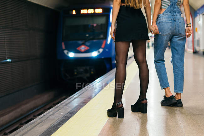 Girlfriends waiting for train — Stock Photo