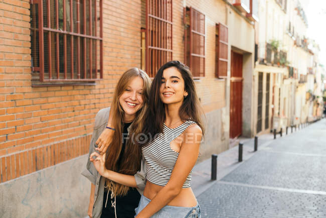 Teen girlfriends posing on street — Stock Photo