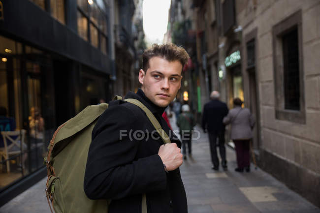 Man in black with backpack — Stock Photo