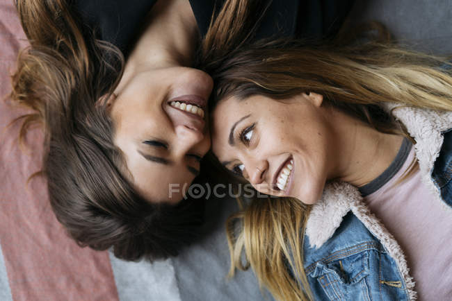 Smiling laying women couple — Stock Photo