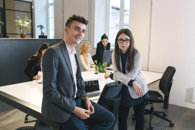 Cheerful colleagues posing in modern office — Stock Photo