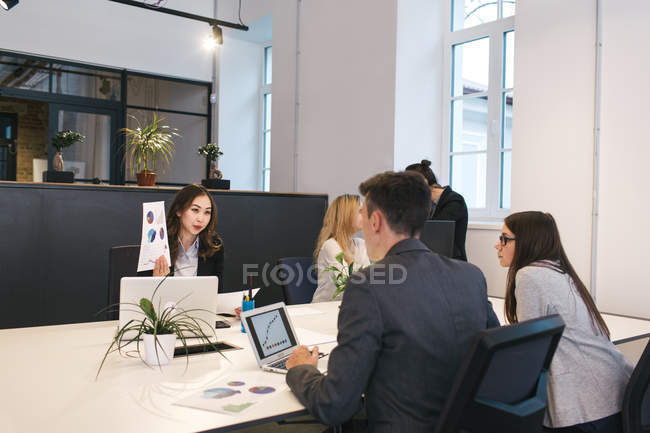 Young colleagues working at table with laptops. — Stock Photo
