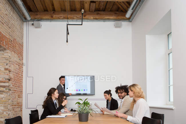 Group of young people working with diagrams in office. — Stock Photo