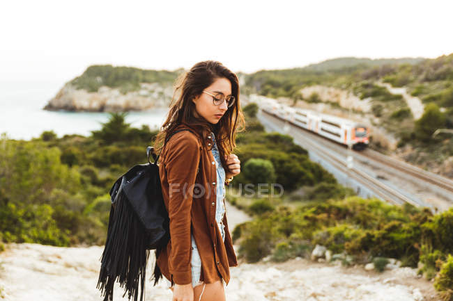 Girl standing on hill and looking down — Stock Photo