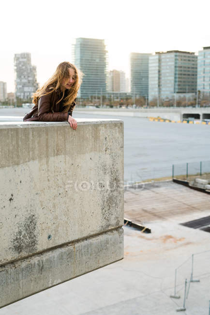 Woman leaning on block — Stock Photo