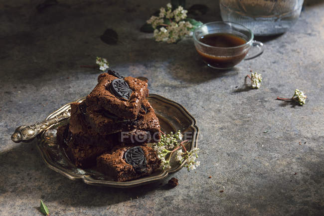 Pile of brownies on metal plate — Stock Photo