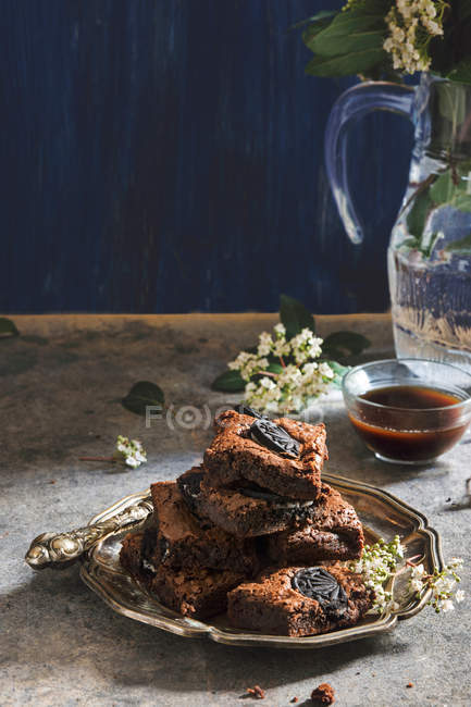 Brownies on metal plate with cup of cofee — Stock Photo