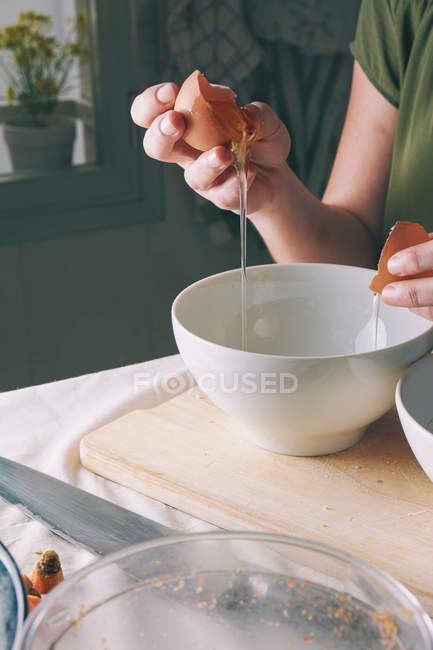 Woman separating egg yolk — Stock Photo