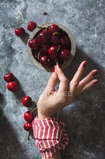 Cherry berries on stone table — Stock Photo