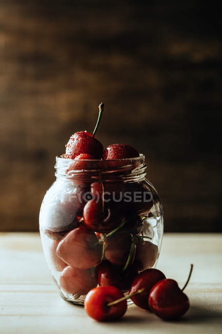Jar with cherry on counter — Stock Photo