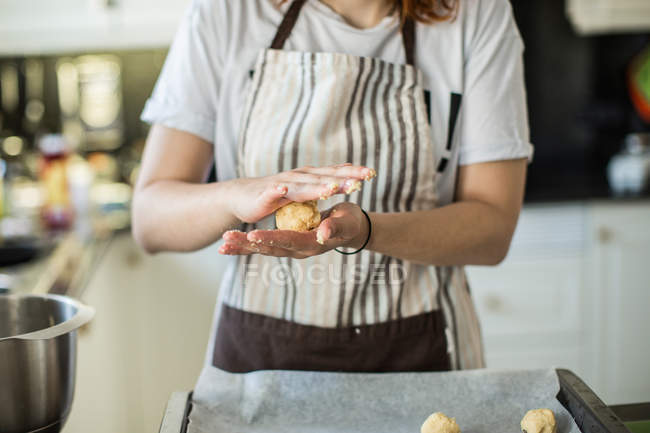 Woman rolling dough ball — Stock Photo
