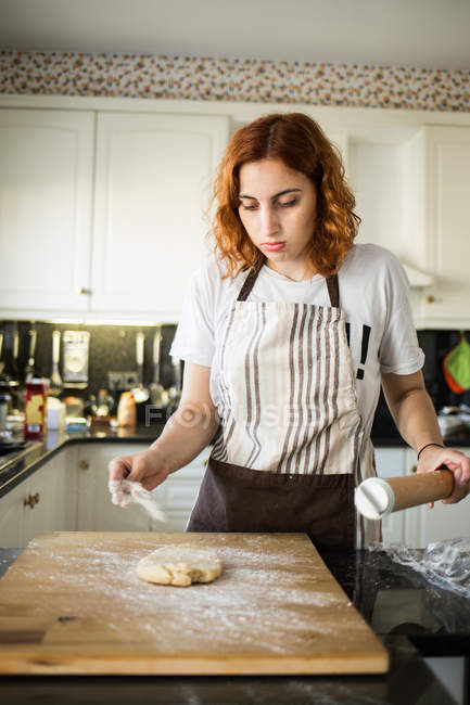 Cook preparing to roll dough — Stock Photo